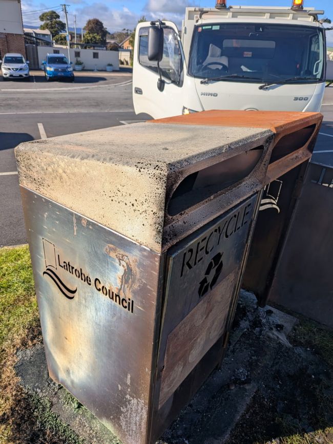 Image shows bins that have been set on fire