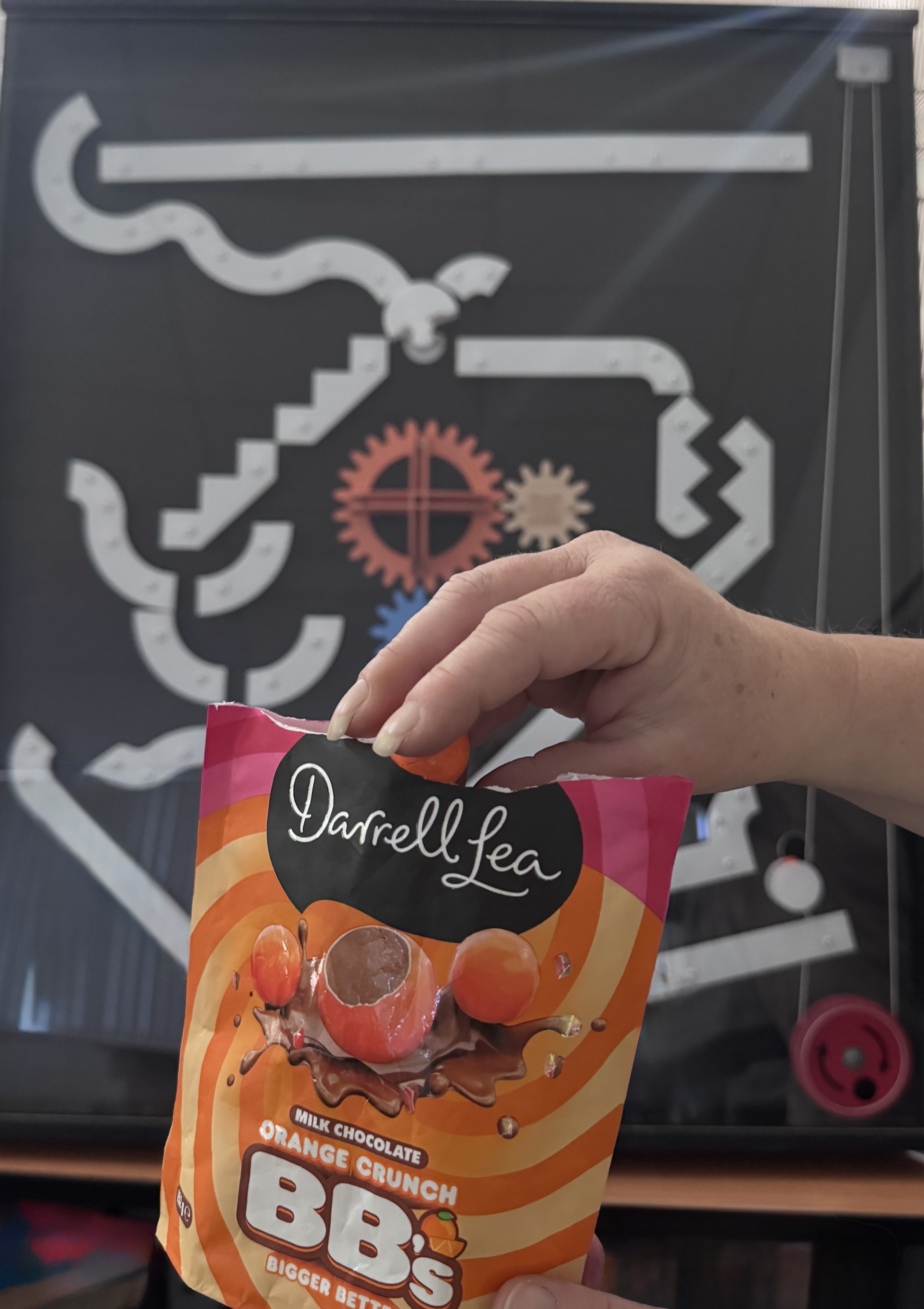 The image shows a bag of Darrell Lea Orange Crunch